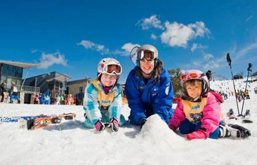 A group of people sitting in the snow Description automatically generated